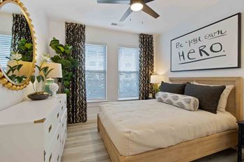 a bedroom with a bed and a ceiling fan